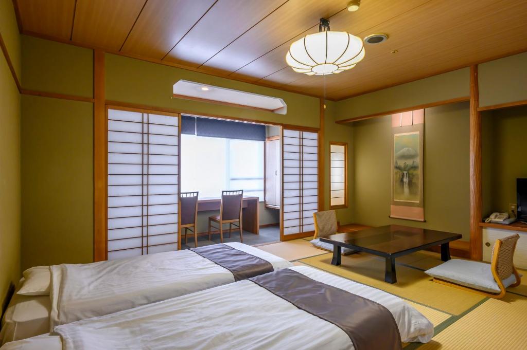 Postel nebo postele na pokoji v ubytování Isawa Tokiwa Hotel