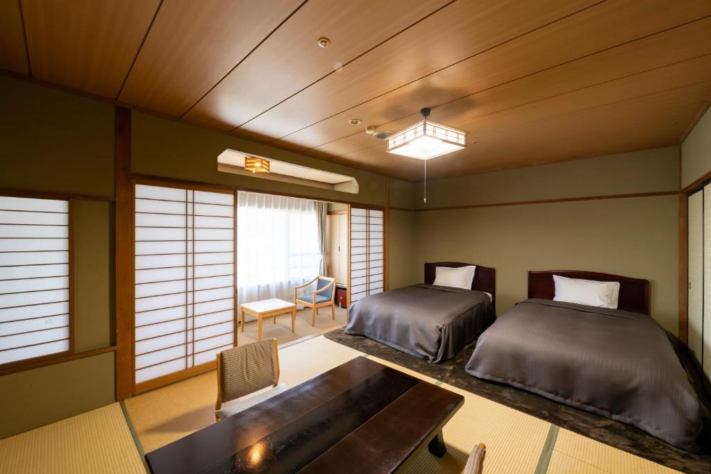 Postel nebo postele na pokoji v ubytování Isawa Tokiwa Hotel