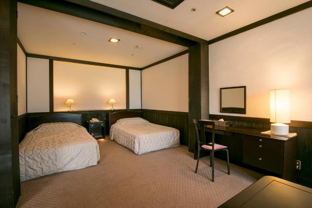 Postel nebo postele na pokoji v ubytování Isawa Tokiwa Hotel