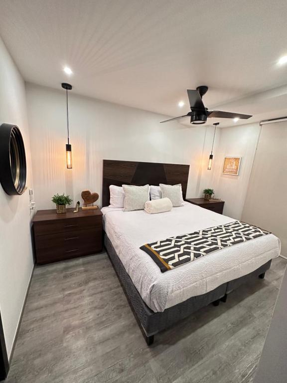 a bedroom with a large bed and a ceiling fan at Entire Luxurious Apartment in Shopping Mall in Mexico City