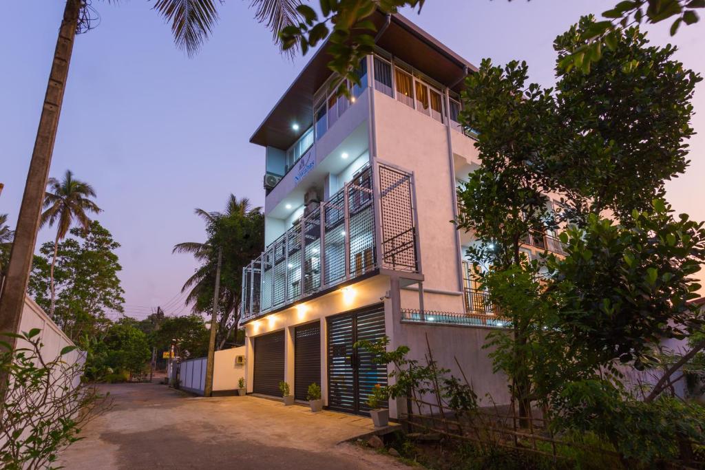 a house with lights on the side of it at Niwahas Apartments Kottawa in Pannipitiya