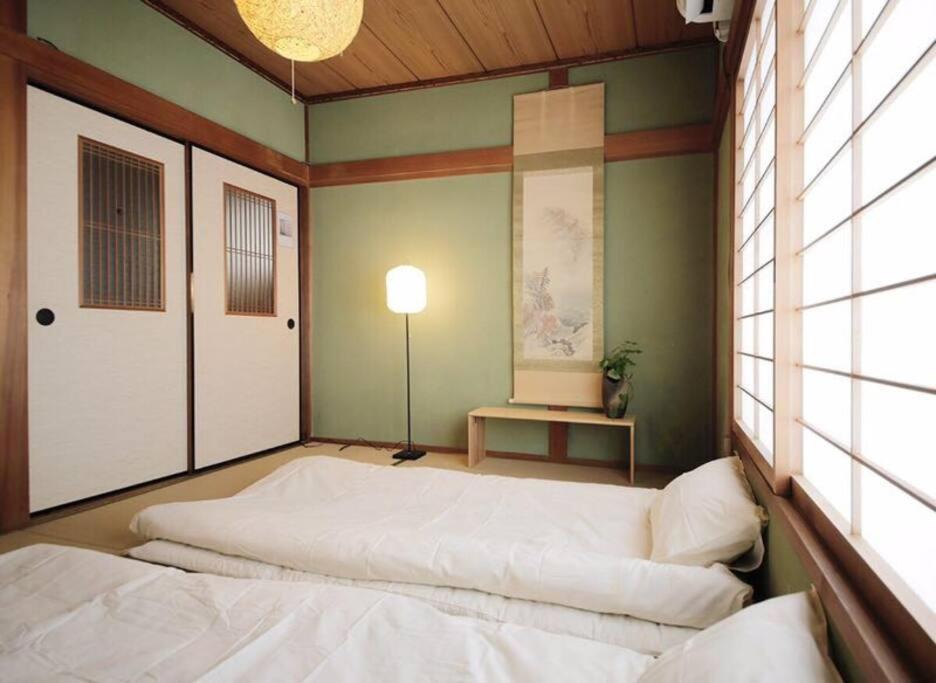 a room with two beds and a lamp in it at Osaka MISAKI Traditional Japanese house 2-6 ppl near station in Osaka