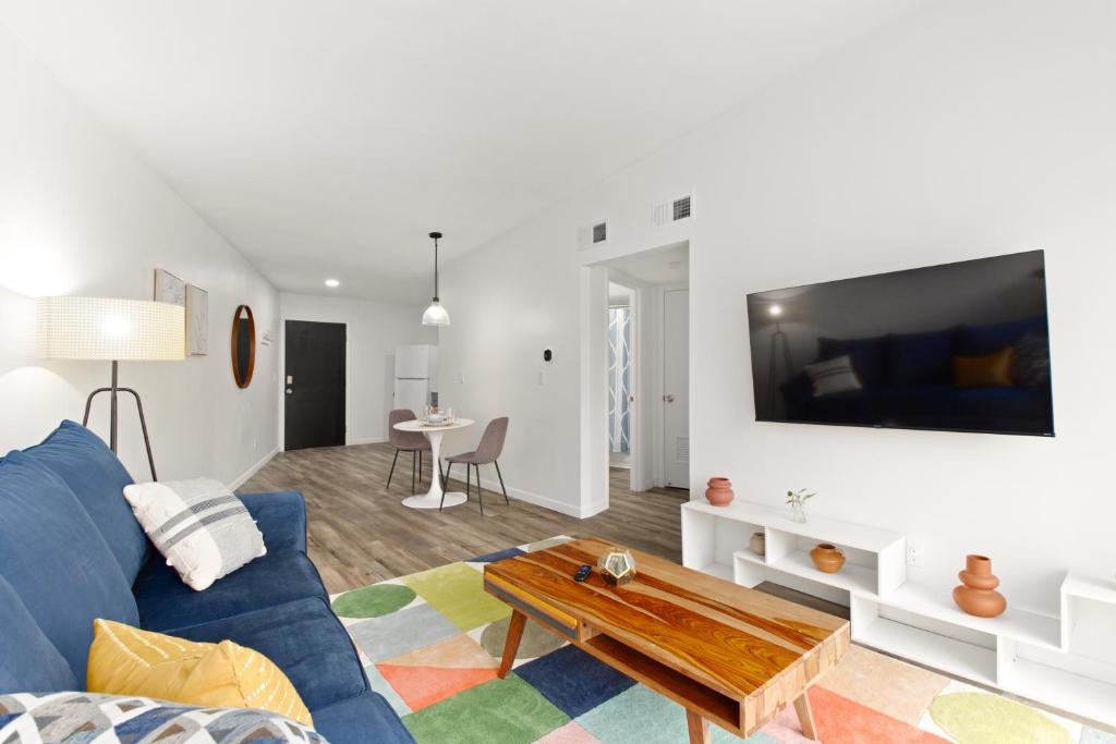 a living room with a blue couch and a table at The Concord Place in Peoria