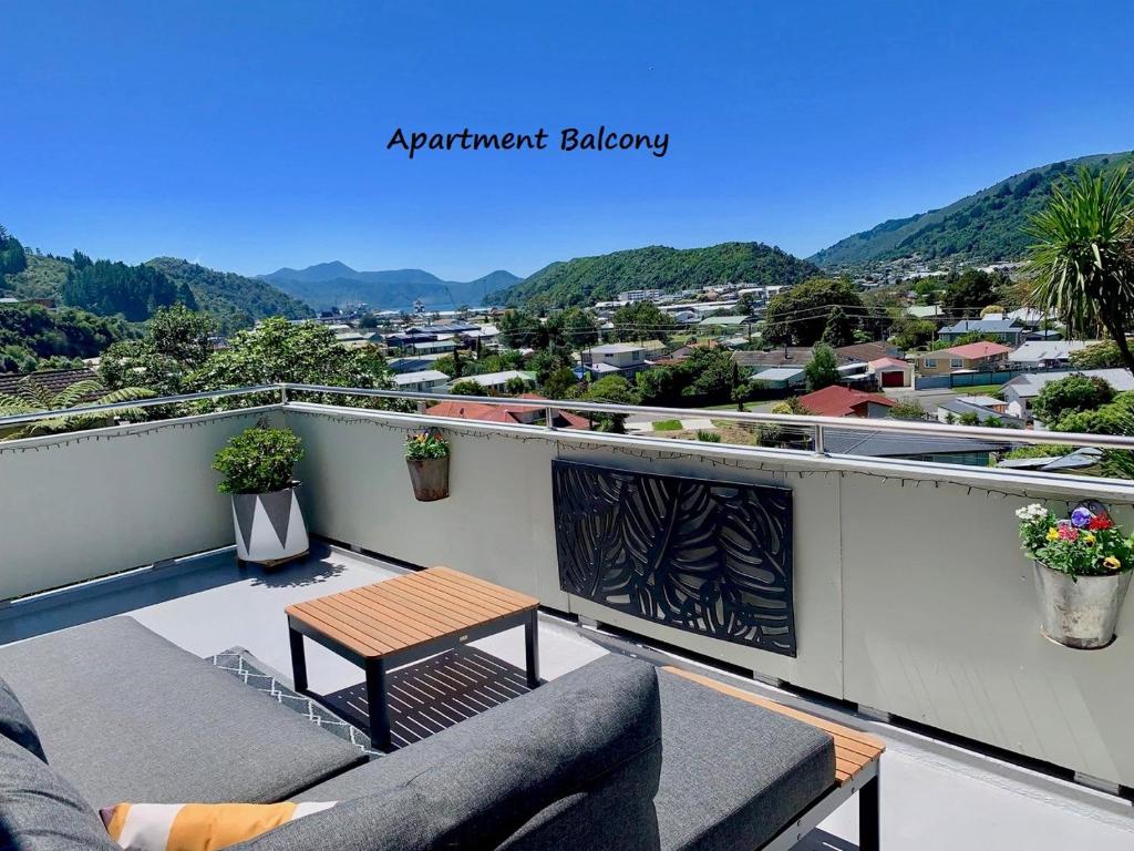 a balcony with a table and a view of a city at Koru Havenz in Picton