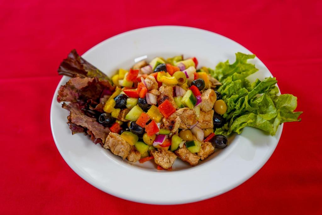 a plate of food with a salad on a red table at After 40 Hotel in Nairobi