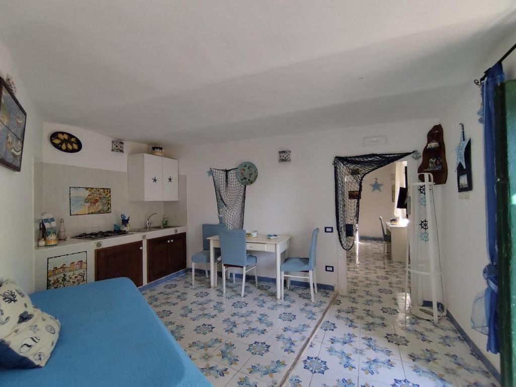 a kitchen and dining room with a table and chairs at La Conchiglia Vietrese in Vietri sul Mare
