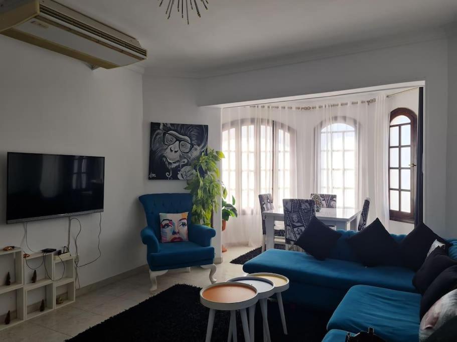a living room with a blue couch and chairs at cozy 2 bedroom apartment in Sharm El Sheikh