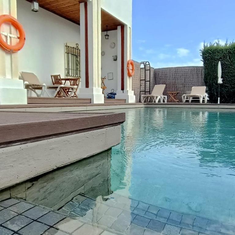 a swimming pool in front of a house at La Luna Blanca in Torremolinos