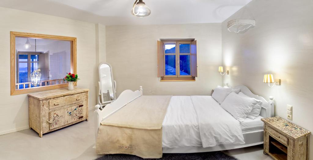A bed or beds in a room at Haones Suites