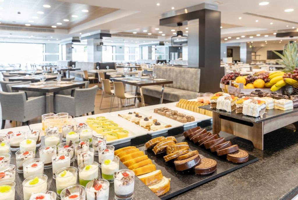 a buffet line with different types of pastries and desserts at Ilunion Calas de Conil in Conil de la Frontera