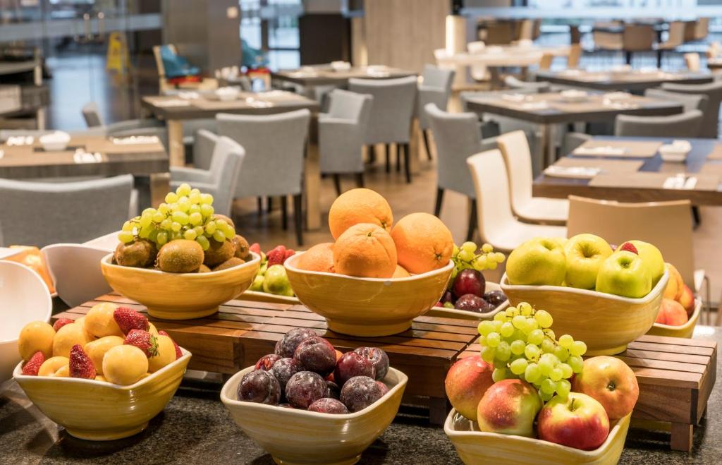 a bunch of bowls of fruit on a table at Ilunion Calas de Conil in Conil de la Frontera