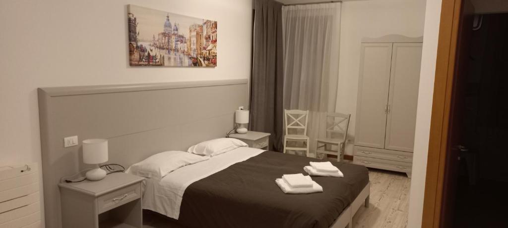 a bedroom with a bed with two towels on it at Palazzetto Canossa in Venice