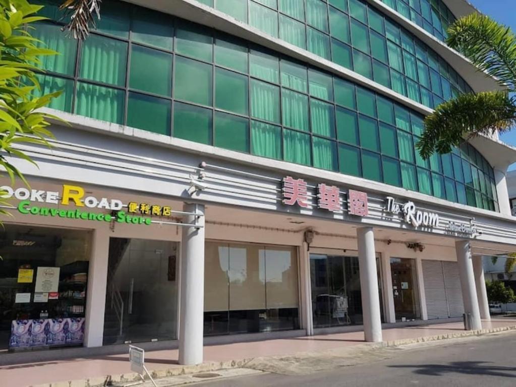 a building with a sign that reads rogue road hire at The Room Hotel in Miri