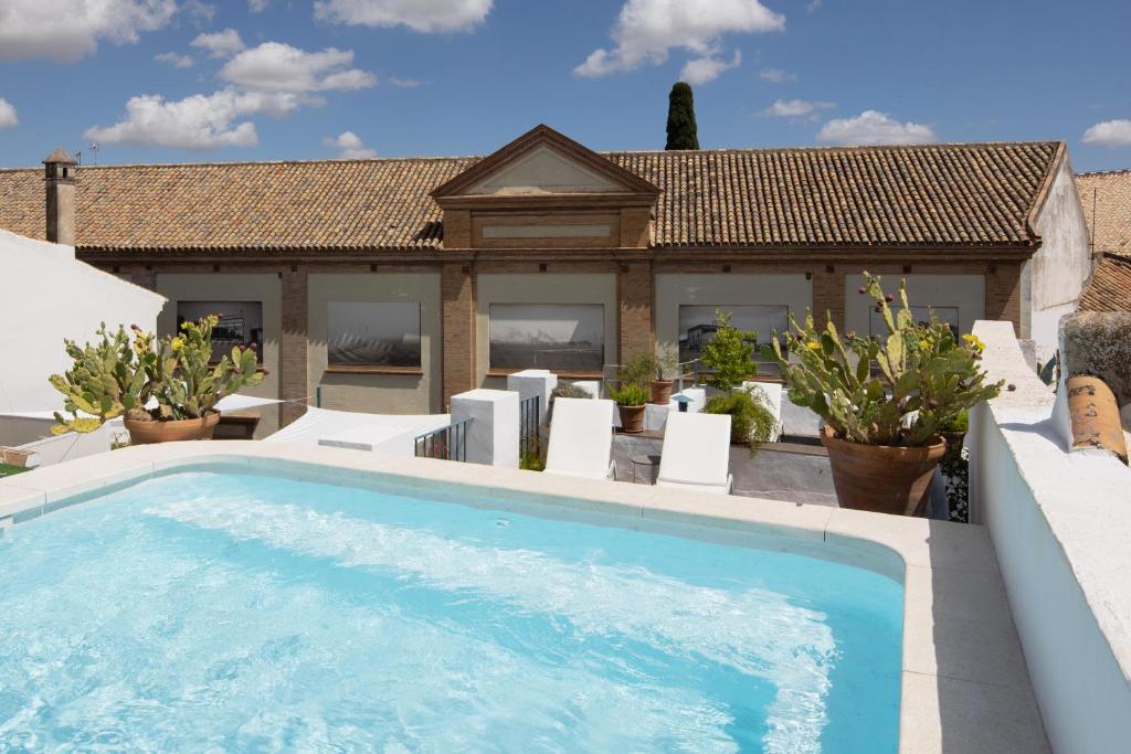 a swimming pool in front of a house at MDD4 Health Experience Hotel - Adults Only in Seville