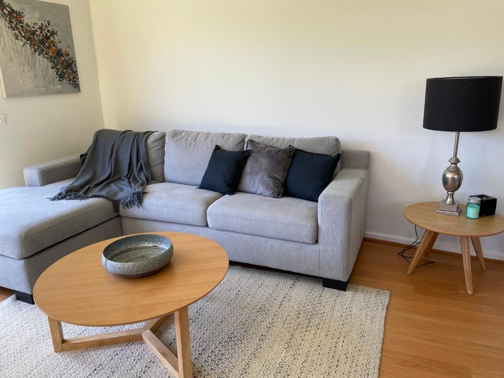 a living room with a couch and a table at Private guesthouse - Minutes from the beach! in Mornington
