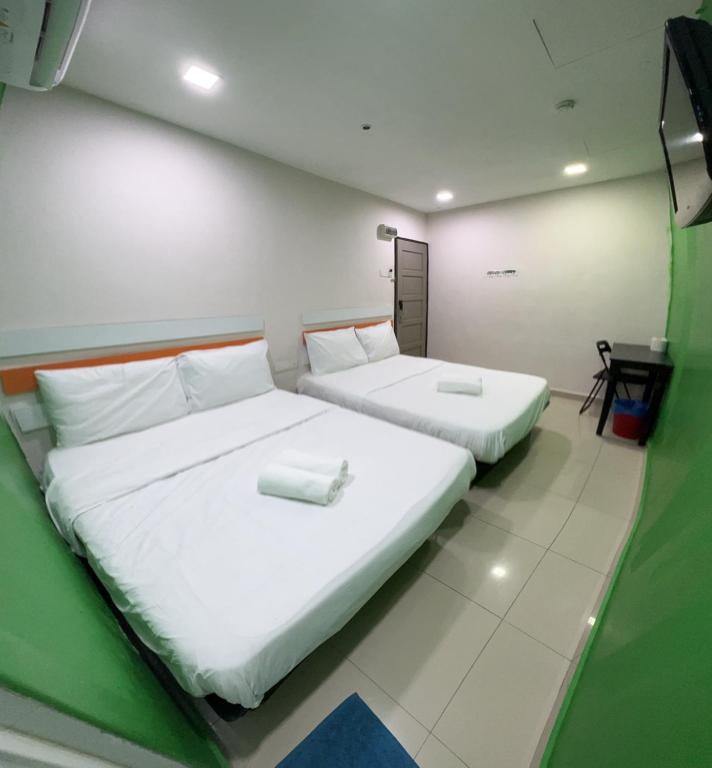Postel nebo postele na pokoji v ubytování Red Orange Hotel Klang - 5 min to Klang Town