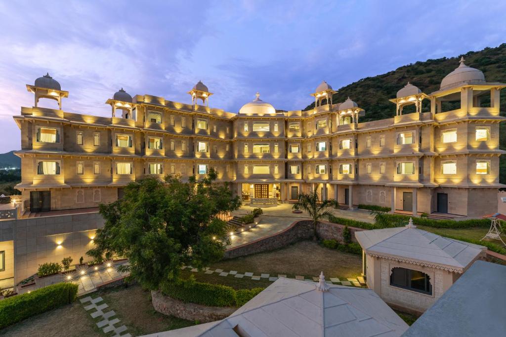 a large building is lit up at night at Traavista Aravali Mahal in Udaipur