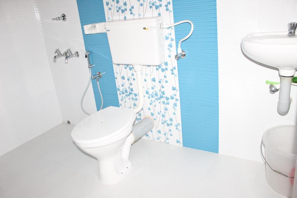 a bathroom with a toilet and a sink at Sajeev Home Stay in Cherai Beach
