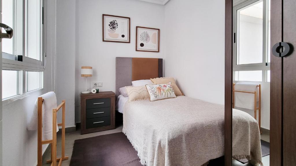 A bed or beds in a room at Apartamento Torre Buena Vista