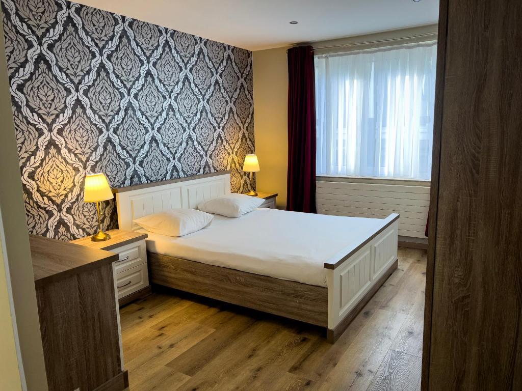 Postel nebo postele na pokoji v ubytování Wellness Apart Hotel