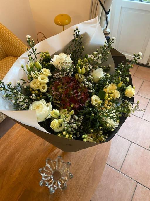 a bouquet of flowers sitting on top of a table at Loft&#47;jardin et parking : Le Petit Clos Bourdet in Honfleur