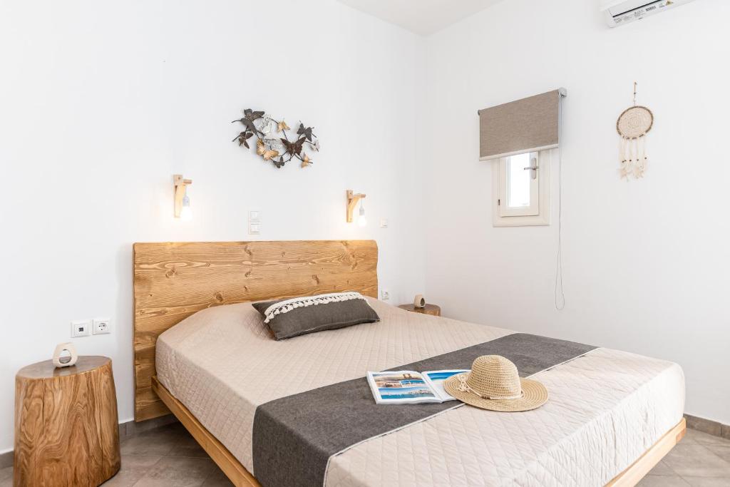 a bedroom with two beds with a hat on top at Sunshine in Naxos Chora