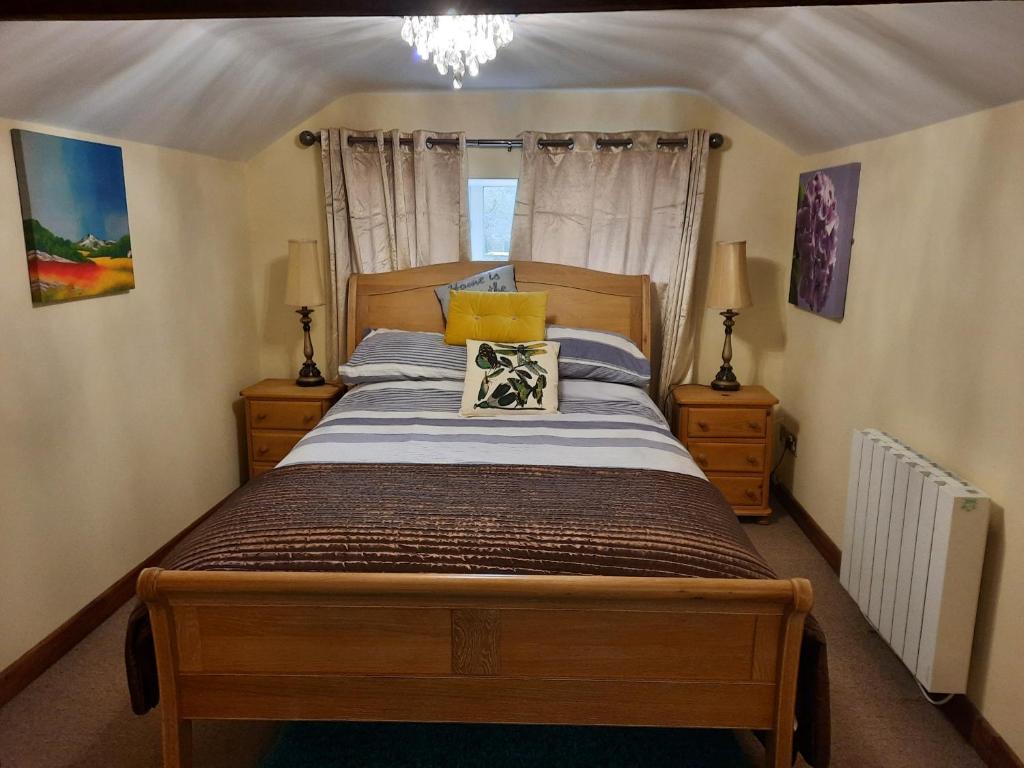a bedroom with a bed and two night stands at Ivy House Barn, Heckington in Heckington