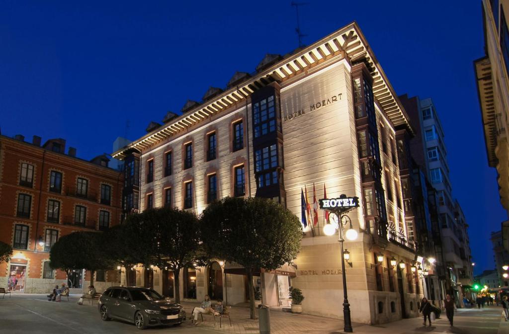 a building on a city street at night at Hotel Mozart in Valladolid
