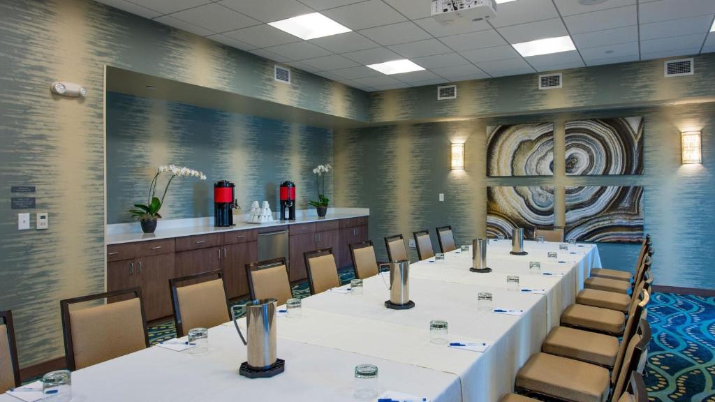 a conference room with a long table and chairs at Hyatt House Naples 5th Avenue in Naples