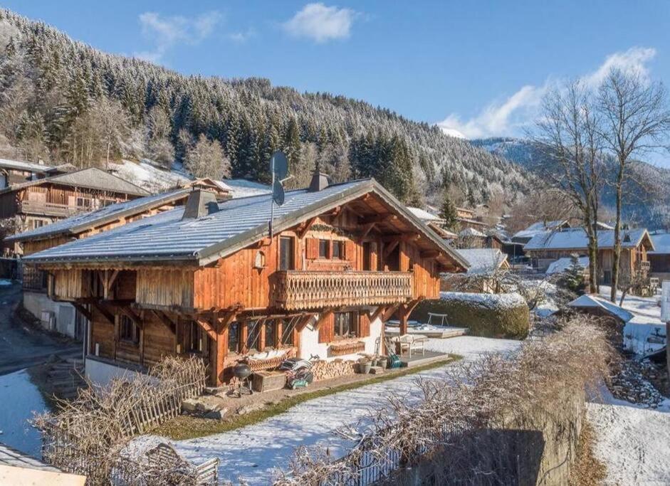 a log cabin in the snow with a mountain at Chalet Renard in Morzine in Montriond