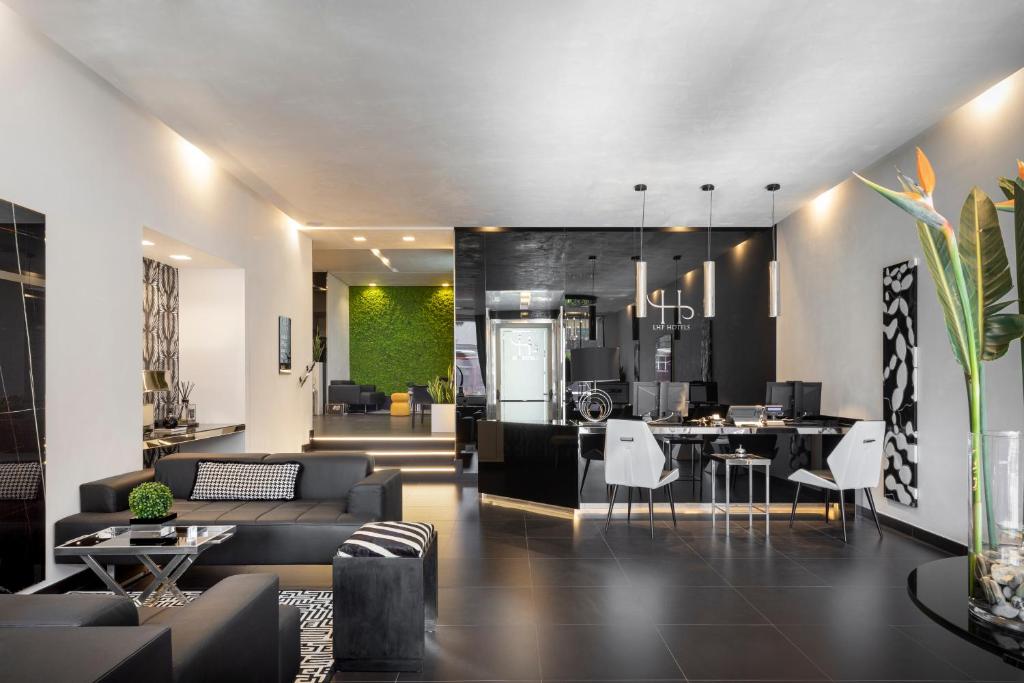 a living room with couches and a dining room at LHP Napoli Palace & SPA in Naples