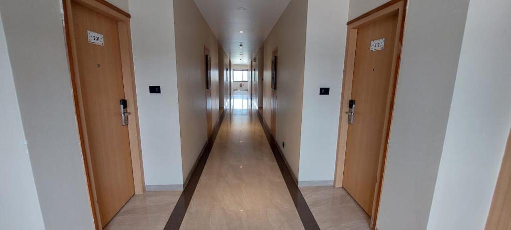 a hallway with a row of doors in a building at Click Hotel Bhuj in Bhuj