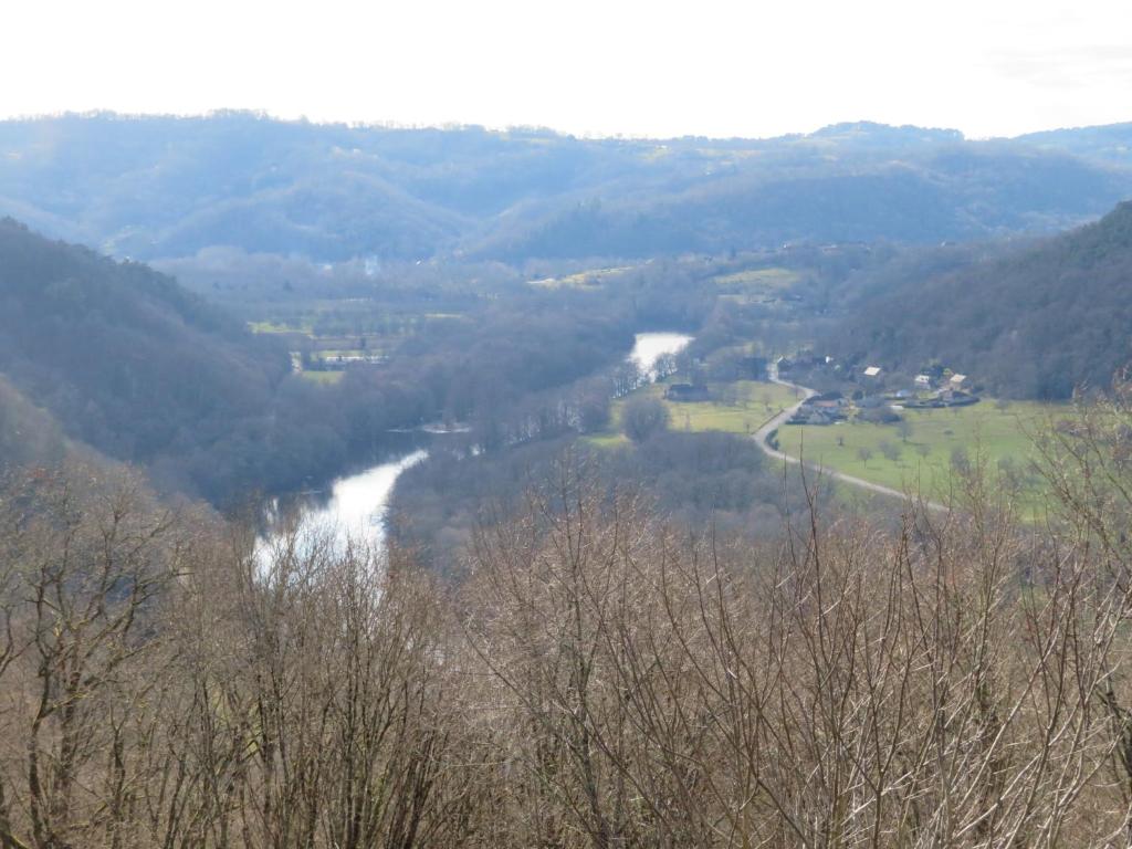 a view of a river in a valley with trees at Château de Chauvac - Chambres et table d'hôtes avec vue sur la rivière in Bassignac-le-Bas