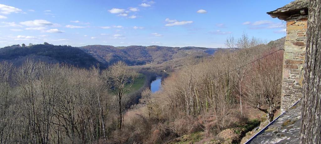a view of a river in the mountains from a building at Château de Chauvac - Chambres et table d'hôtes avec vue sur la rivière in Bassignac-le-Bas