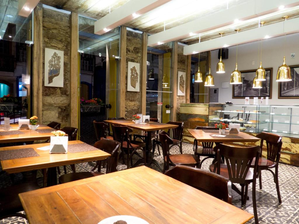 an empty restaurant with wooden tables and chairs at Pousada Solar da Ópera in Ouro Preto