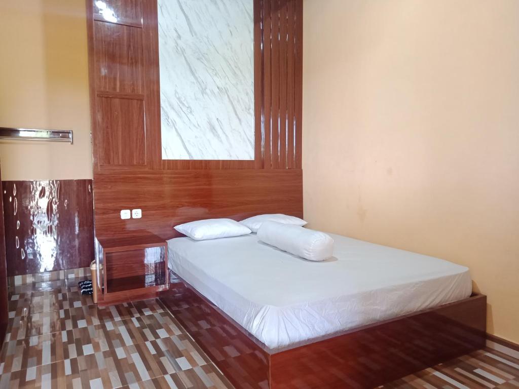 a small bedroom with a bed with a window at An Nur Homestay Bira Beach in Bira