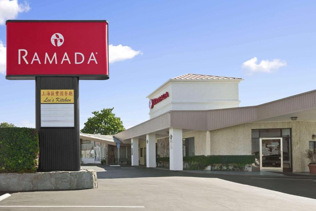 a ramada sign in front of a store at Ramada by Wyndham Torrance in Torrance