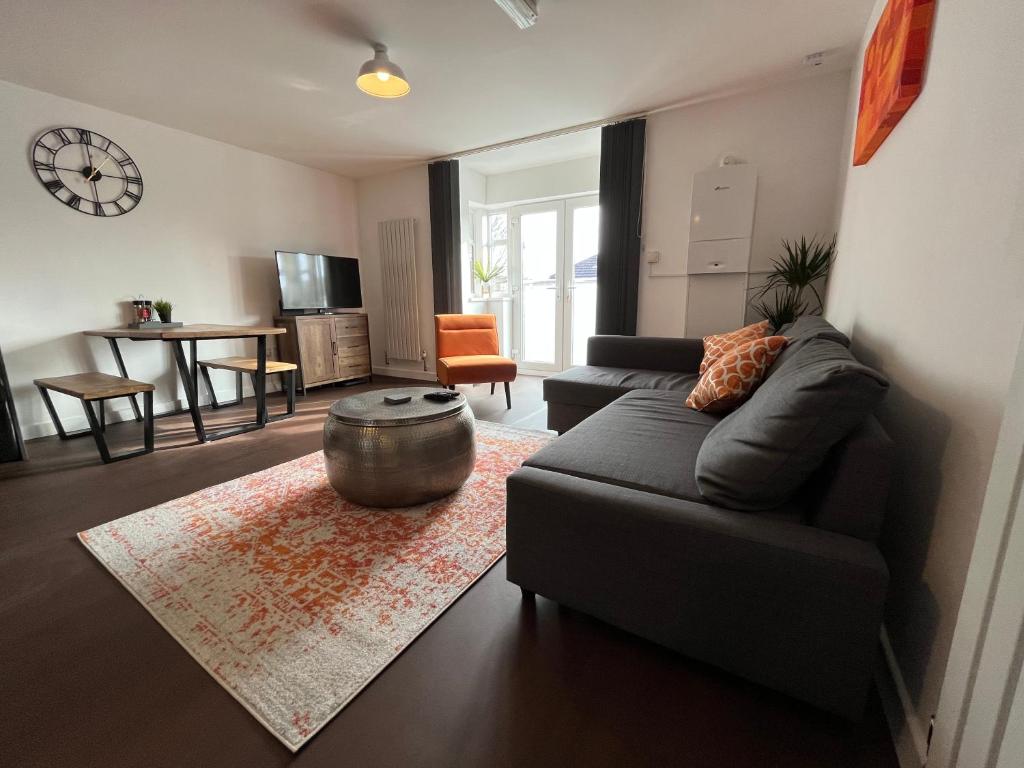 uma sala de estar com um sofá e uma mesa em Stylish 2 Bed Riverside Flat, Single or Kingsize beds, Free Parking em Southampton