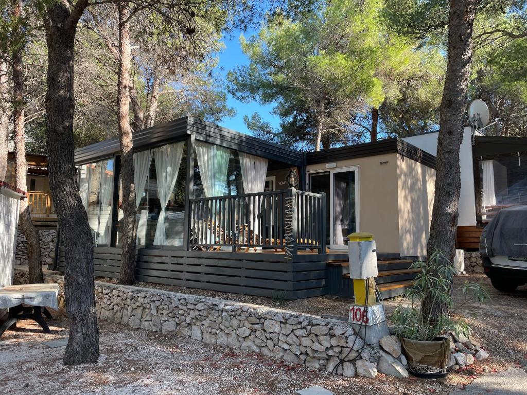 a house in the woods with a stone wall at Maja Vita _ Maja in Drage