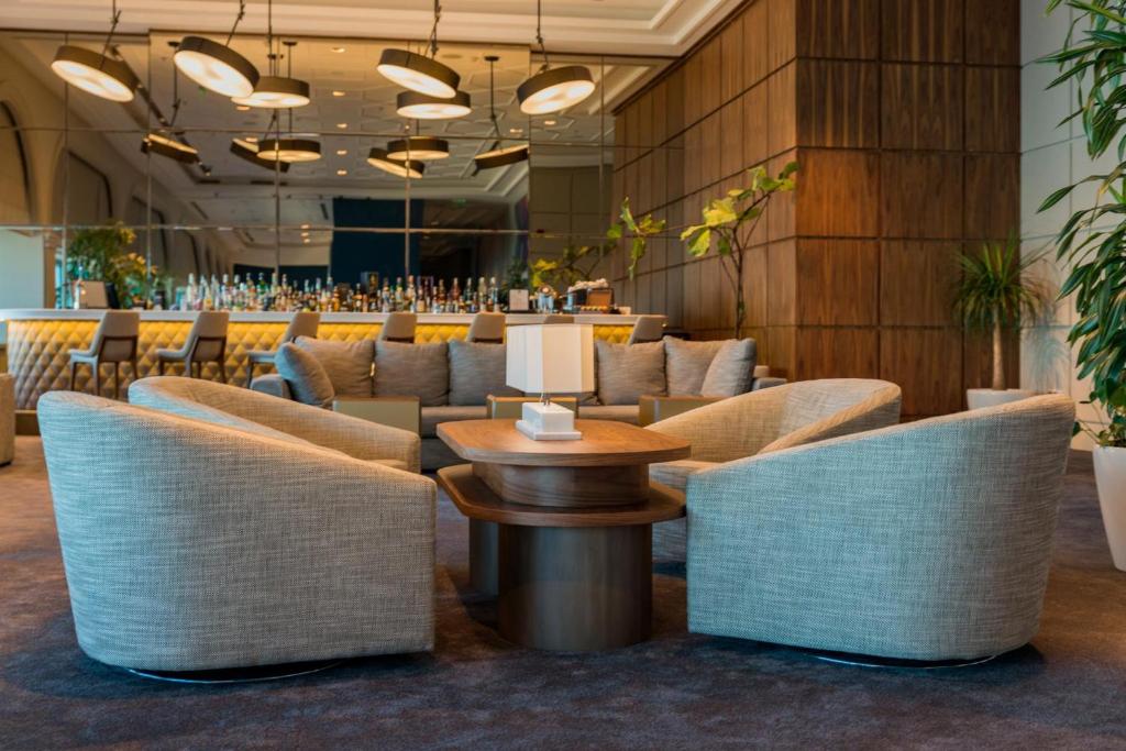 a restaurant with couches and a table and chairs at International Hotel Casino & Tower Suites in Golden Sands