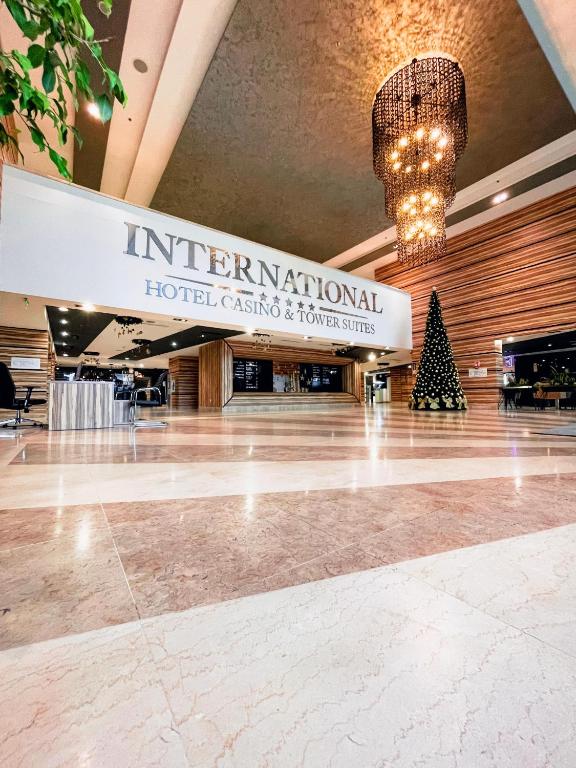 a hotel lobby with a christmas tree in the center at International Hotel Casino & Tower Suites in Golden Sands