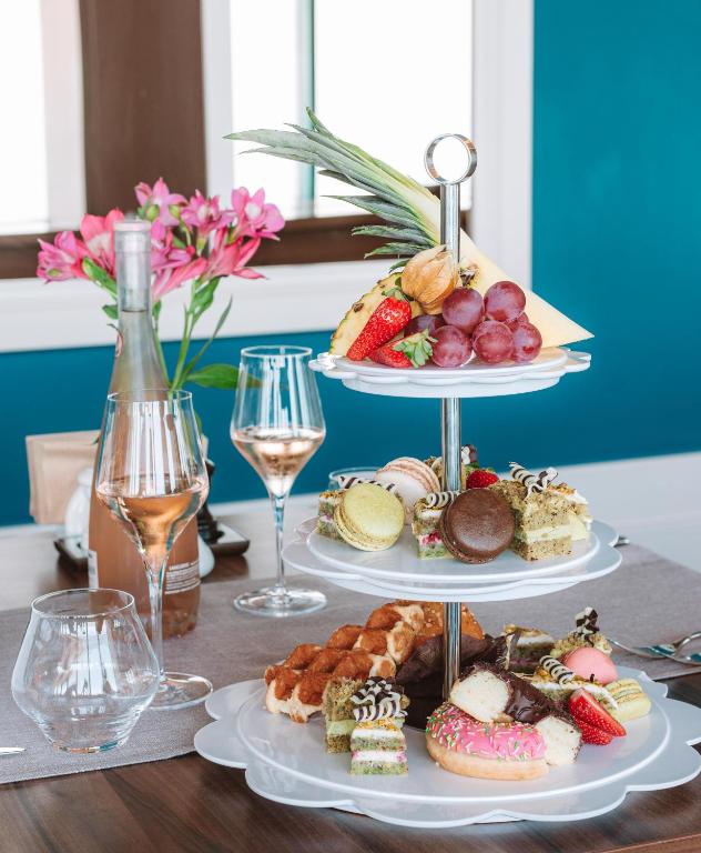 a table with three plates of food and glasses of wine at International Hotel Casino & Tower Suites in Golden Sands