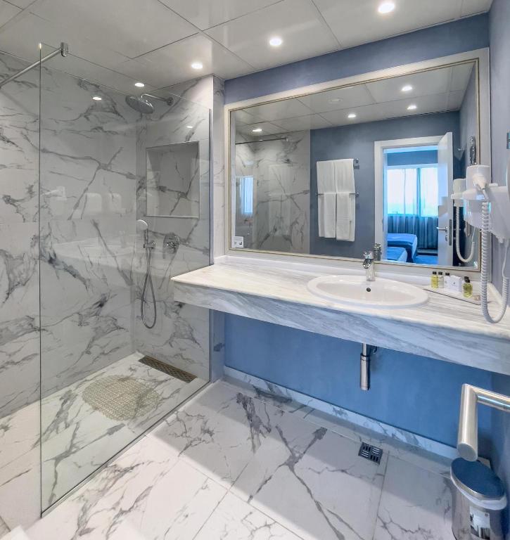 a bathroom with a sink and a mirror at International Hotel Casino & Tower Suites in Golden Sands