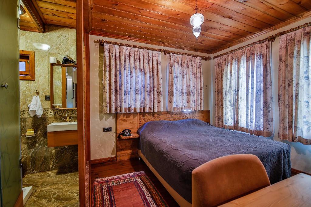 Postel nebo postele na pokoji v ubytování Kum Pansiyon