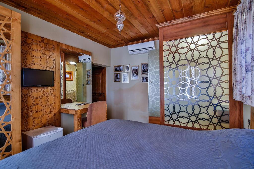 Postel nebo postele na pokoji v ubytování Kum Pansiyon