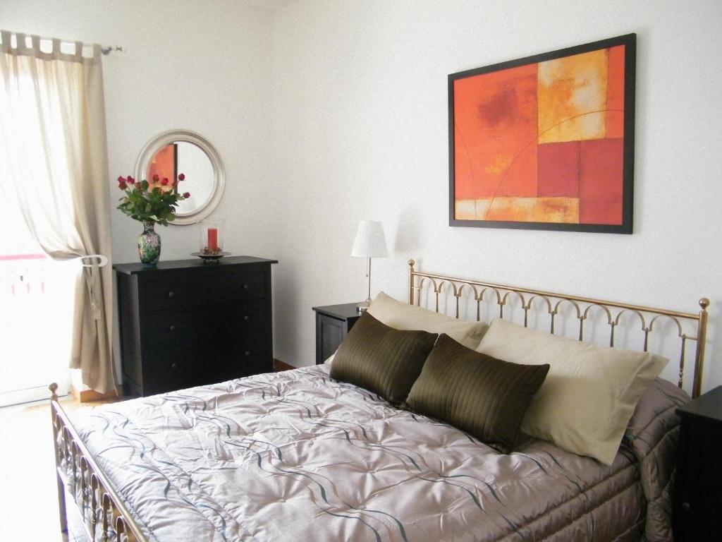 1 dormitorio con 1 cama y una pintura en la pared en B&B A Casa Di Mario Scafati, en Scafati
