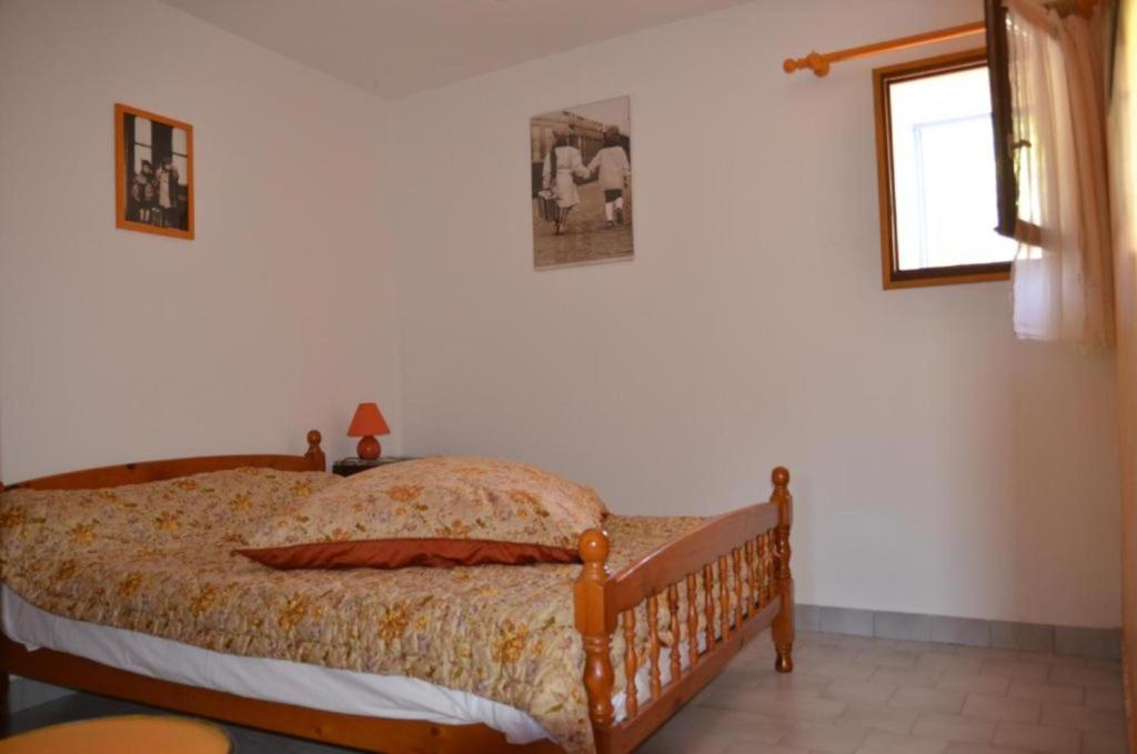 a bedroom with a bed in a room with a window at Bastide la Fondue in Allemagne-en-Provence