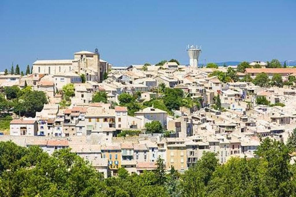 a group of houses on a hill with a water tower at Bastide la Fondue in Allemagne-en-Provence