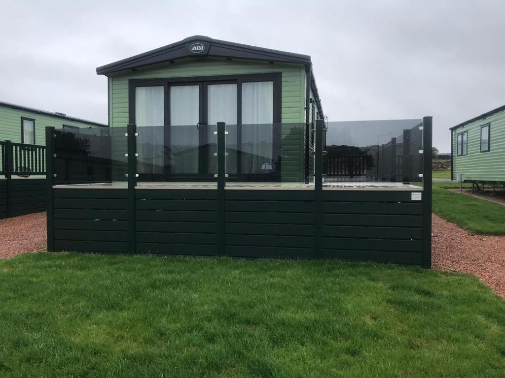a green and black building on the grass at 41 Lade Links St Andrews Holiday Park in St. Andrews