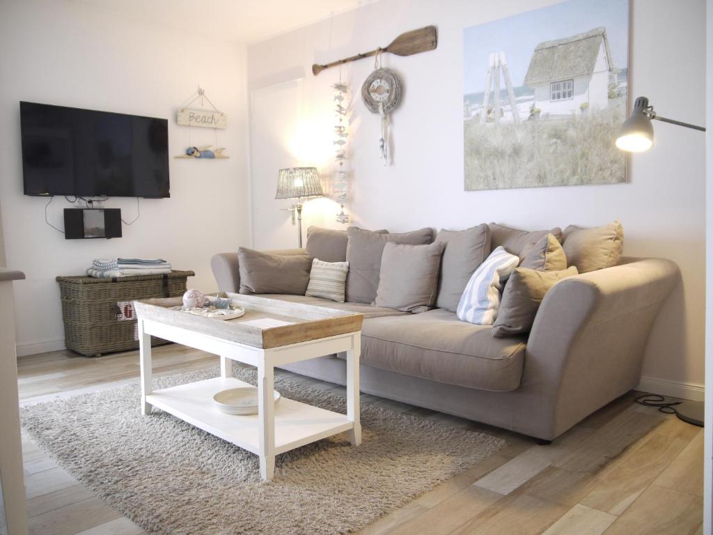 a living room with a couch and a table at Strandperle 5 in Scharbeutz